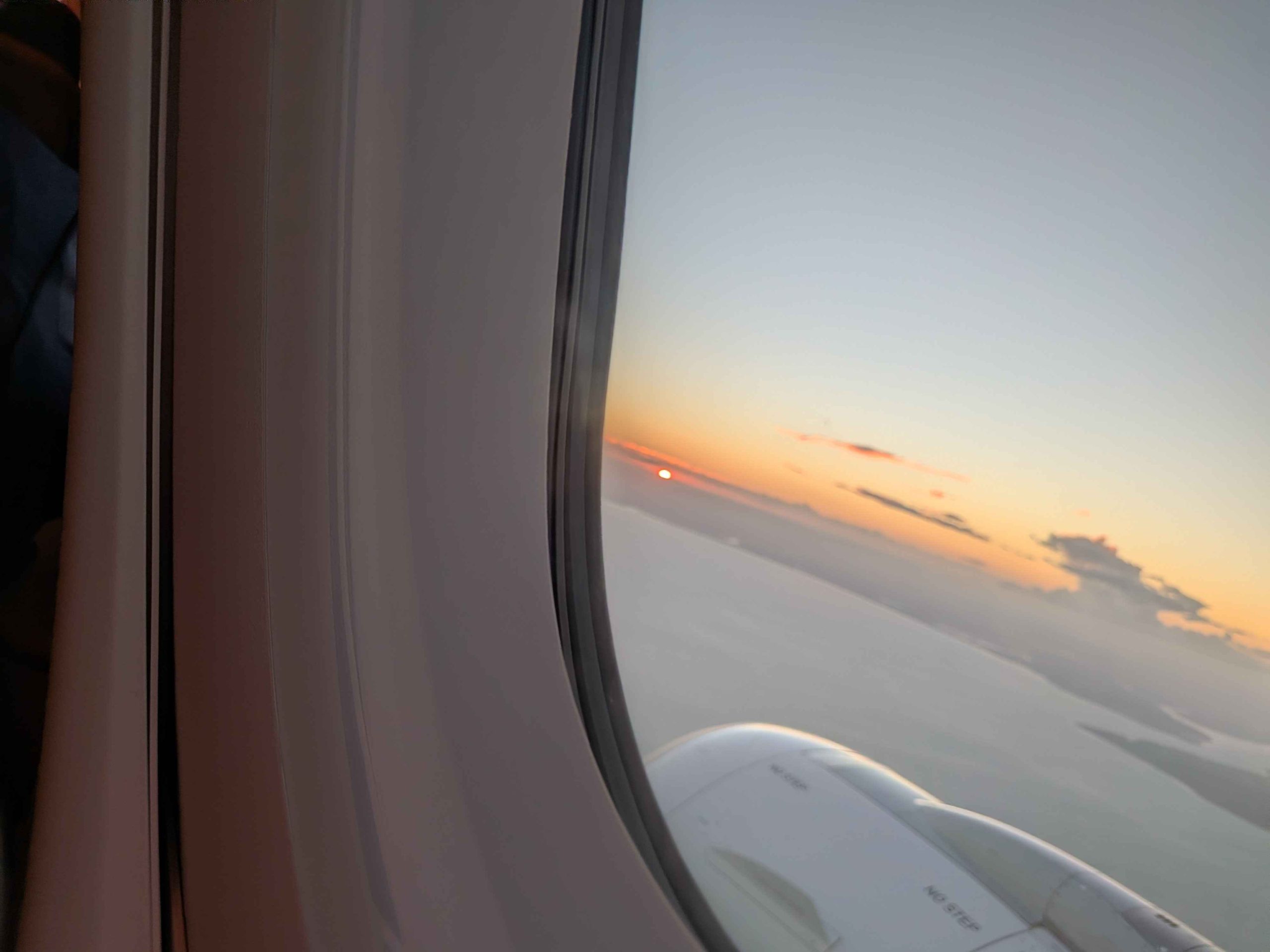 Sunset view from Qantas A321-XLR window at altitude